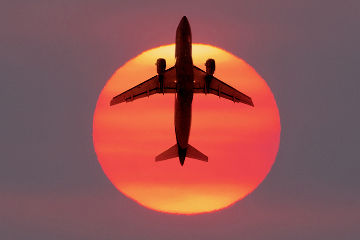 Airplane flying in front of the Sun. Credit: AscentXmedia / Getty Images