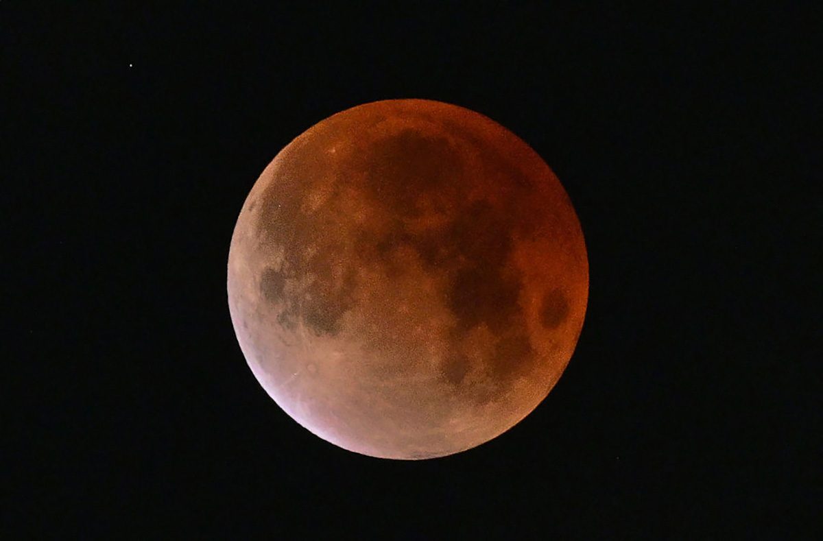 The Moon turns red during a lunar eclipse. Photo by Frederic J. BROWN / AFP via Getty Images