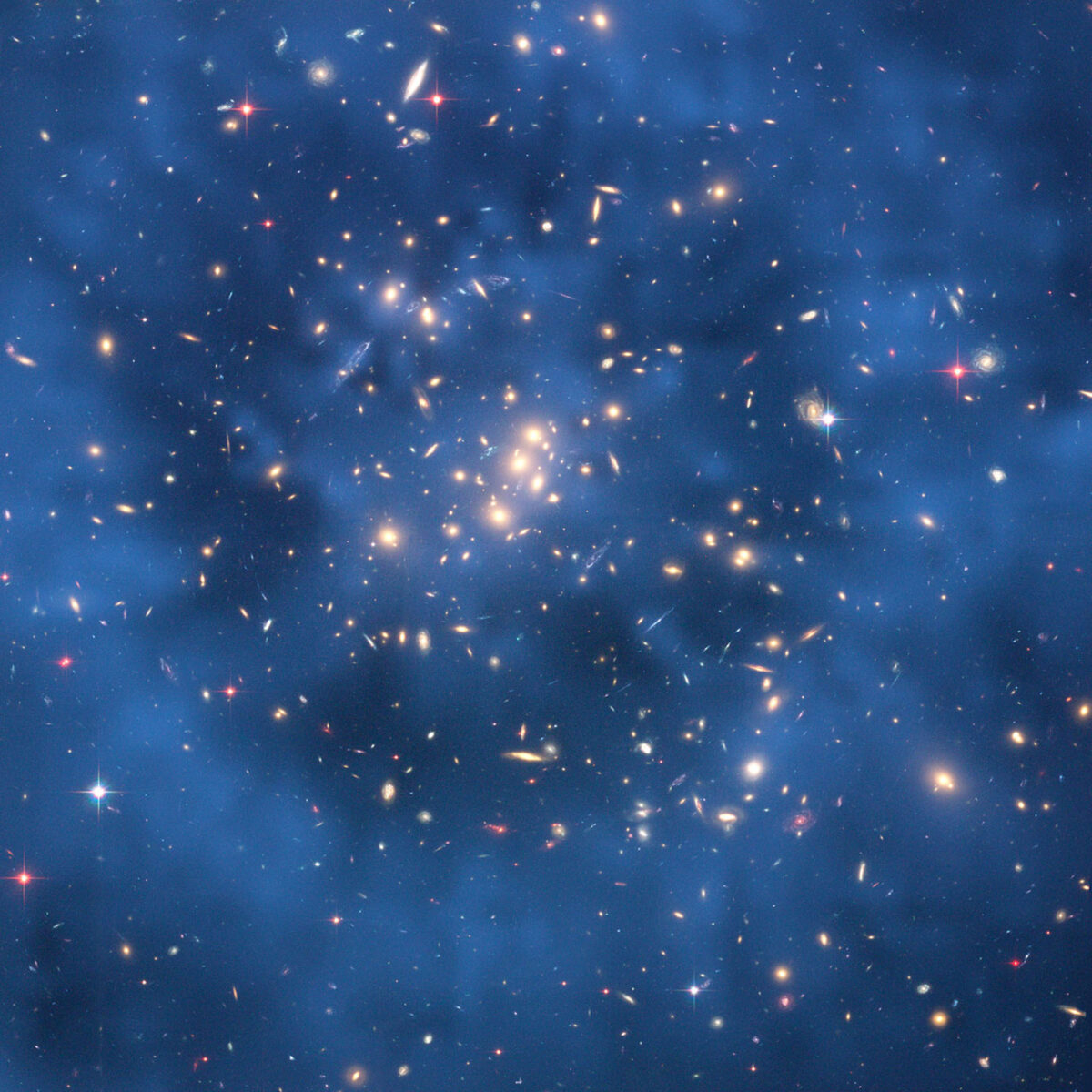We can only see dark matter from its effect on stars and galaxies. Here, astronomers used the images of galaxies distorted by gravitational lensing to map out the dark matter, shown in blue. Credit: NASA, ESA, M. Jee and H. Ford (Johns Hopkins University)