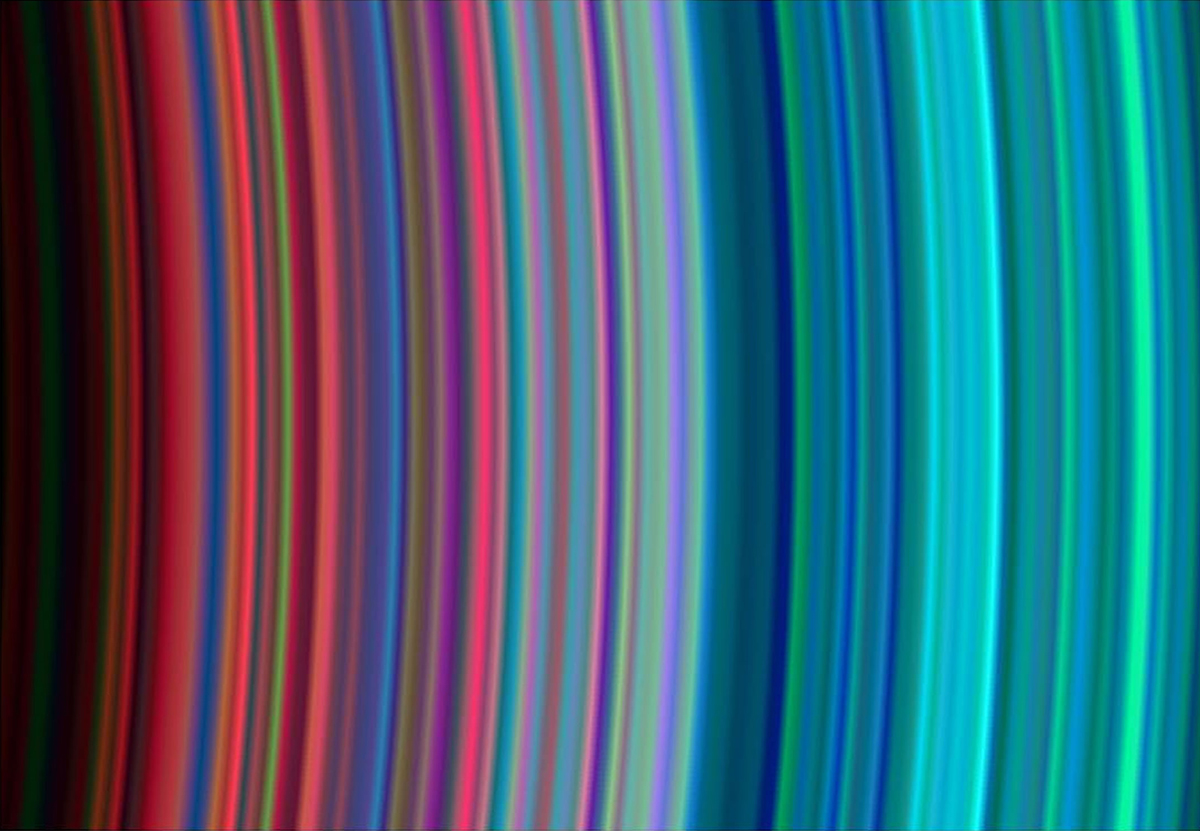 A view of Saturn's rings captured in 30 June 2004. The varying hues are caused not by Enceladus's plumes, but by of differences in their composition, as seen by the Cassini spacecraft’s Ultraviolet Imaging Spectrograph. Credit: NASA/JPL/University of Colorado