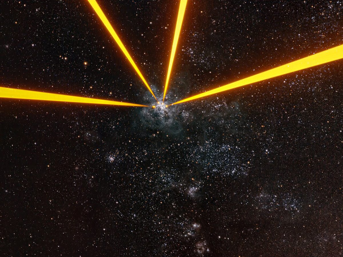 Beams from lasers installed on European Space Telescope's Very Large Telescope Interferometer, fired at the Tarantula Nebula. Credit: A. Berdeu/ESO