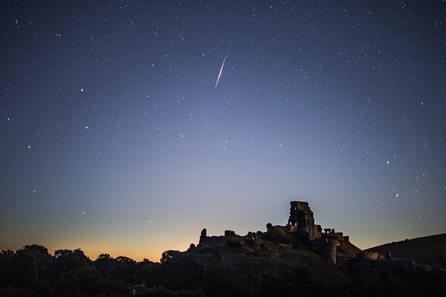 A Perseid meteor seen in the night sky above Corfe Castle, Dorset, United Kingdom, 12 August 2016. Credit: Dan Kitwood/Getty Images. A Perseid meteor seen in the night sky above Corfe Castle, Dorset, United Kingdom, 12 August 2016. Credit: Dan Kitwood/Getty Images.