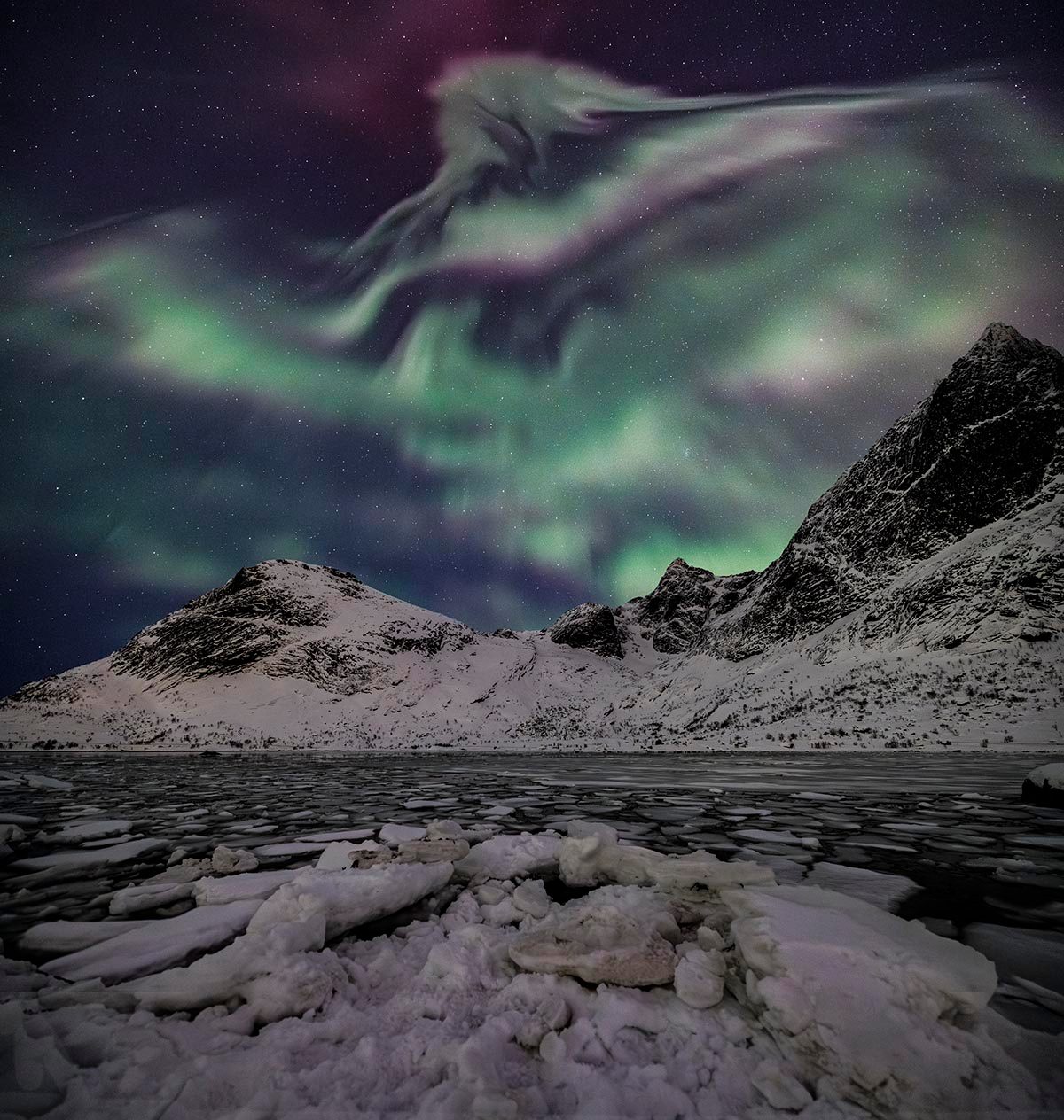 Eagle Aurora © Jennifer Rogers (UK), Aurorae category. Taken with an astro-modified Canon EOS R6 Mk II camera, 15 mm f/2.8, Foreground: ISO 3200, 2 x 8-second exposures; Sky: ISO 6400, 2-second exposure. Location: Flakstad, Lofoten, Norway, 19 February 2026