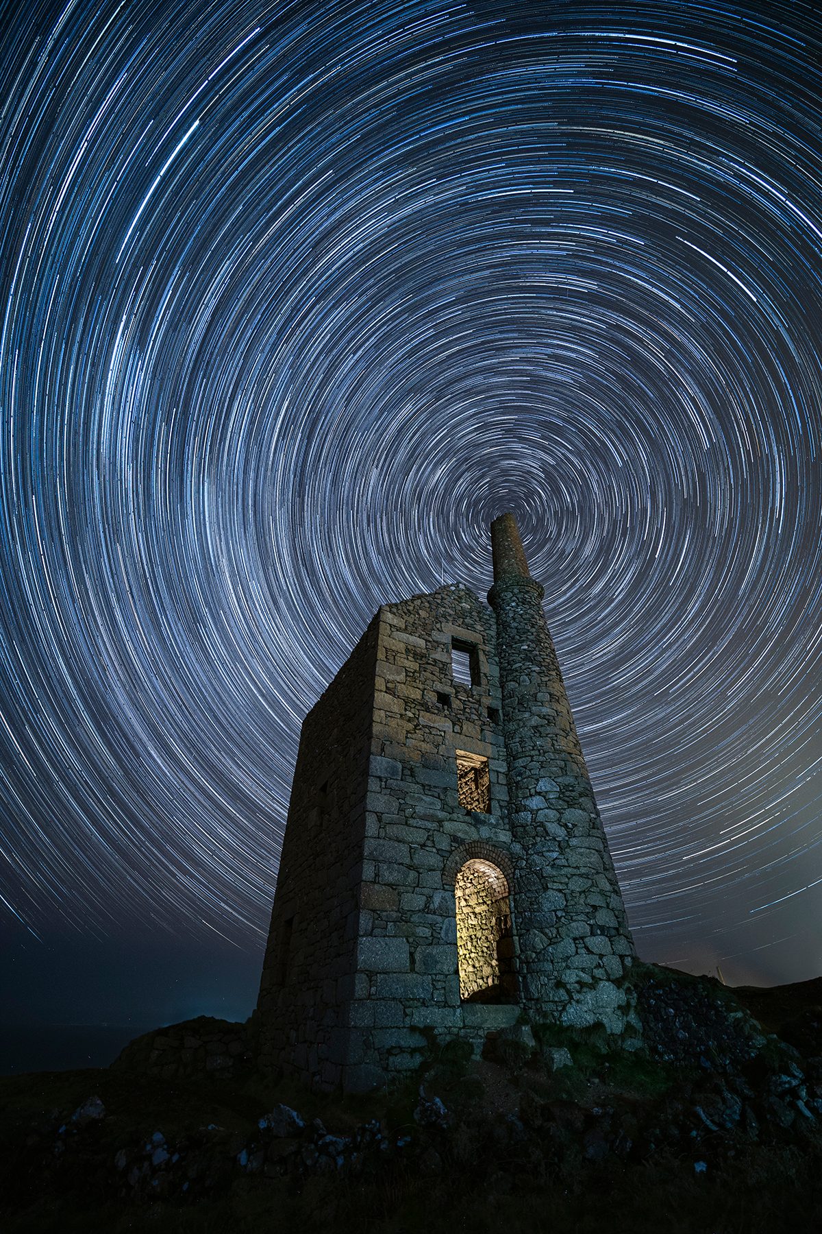 Vortex © Jennifer Rogers (UK), People and Space category. Taken with a Canon EOS 5D Mark IV camera, 14 mm f/2.8, ISO 1600, Foreground: 1 x 60-second exposure; Star trail: 72 x 60-second exposures. Location: West Wheal Owles, Cornwall, England, 22 February 2025