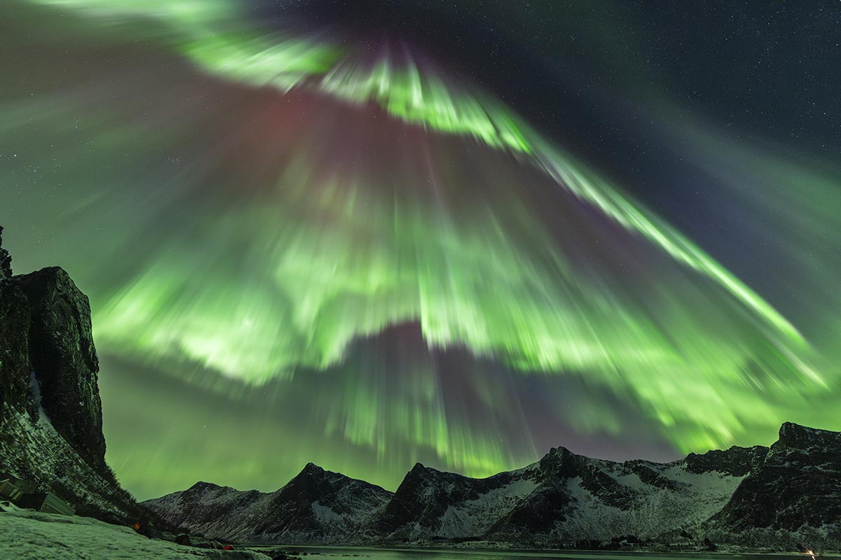 An Auroral Deluge © Julien Cadena (France), Aurorae category. Taken with a Sony Alpha 7 IV camera, 14 mm f/2.8, ISO 3200, 1-second exposure. Location: Lyngen, Troms, Norway, 20 January 2026