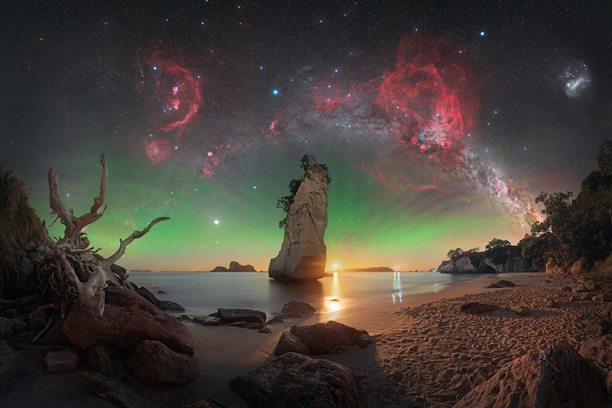 Te Hoho Rock Moonrise © Evan McKay (Aotearoa/New Zealand), Skyscapes category. Taken with a Nikon Z 6a camera, Sky-Watcher EQ6-R Pro mount, Move Shoot Move Nomad star tracker, Sigma 40 mm Art lens, Optolong L-Para filter, 40 mm, Foreground: f/2.8, ISO 800, 30-second exposure; Sky: f/2, ISO 1600, multiple 15-second RGB exposures, multiple 2-minute exposures with filter. Location: Cathedral Cove, Waikato, North Island, Aotearoa New Zealand, 8 January 2026