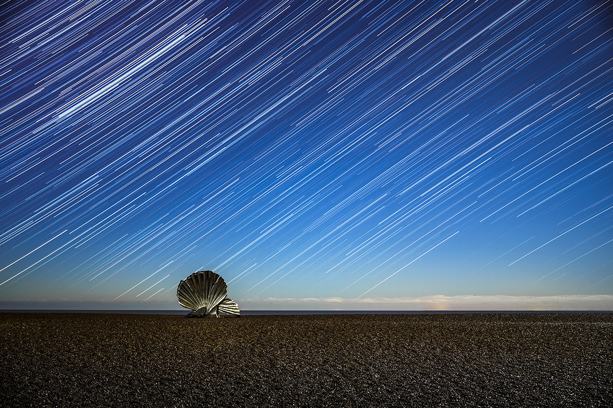 I Hear the Stars © João Yordanov Serralheiro (Portugal), Skyscapes category. Taken with a Sony Alpha 7 III camera, 35 mm f/2.8, ISO 400, 120 x 30-second exposures. Location: Aldeburgh Beach, Suffolk, England, 30 November 2025