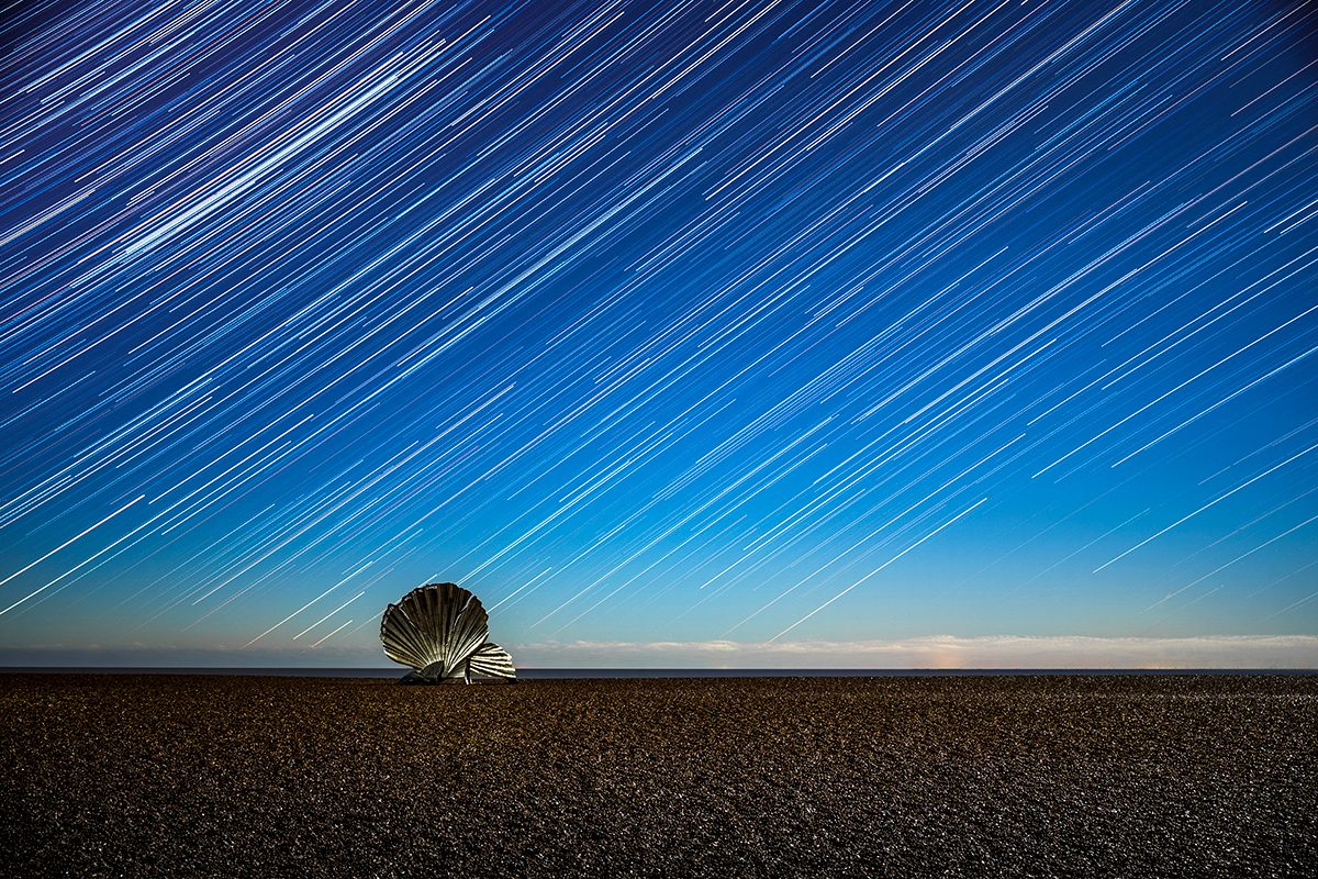 I Hear the Stars © João Yordanov Serralheiro (Portugal), Skyscapes category. Taken with a Sony Alpha 7 III camera, 35 mm f/2.8, ISO 400, 120 x 30-second exposures. Location: Aldeburgh Beach, Suffolk, England, 30 November 2025