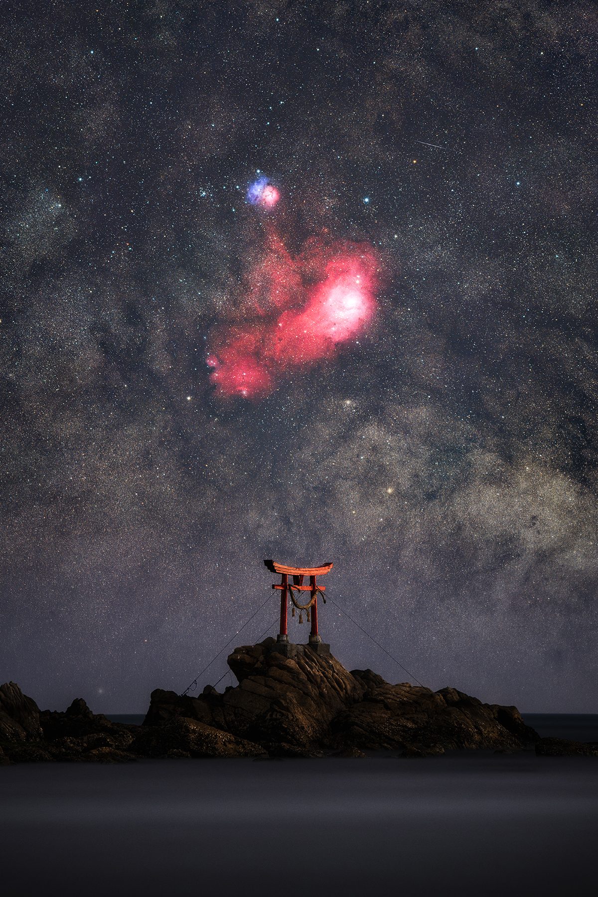 The Celestial Gate © Yoshiki Abe (Japan), Skyscapes category. Taken with a Sony ILCE-7RM5 camera, 200 mm, Foreground: f/5.6, ISO 320, 240-second exposure; Sky: f/4.0, ISO 3200, 34 x 60-second exposures; H-alpha: f/2.8, ISO 6400, 28 x 120-second exposures. Location: Kitsuki, Ōita Prefecture, Japan, 22 February 2026