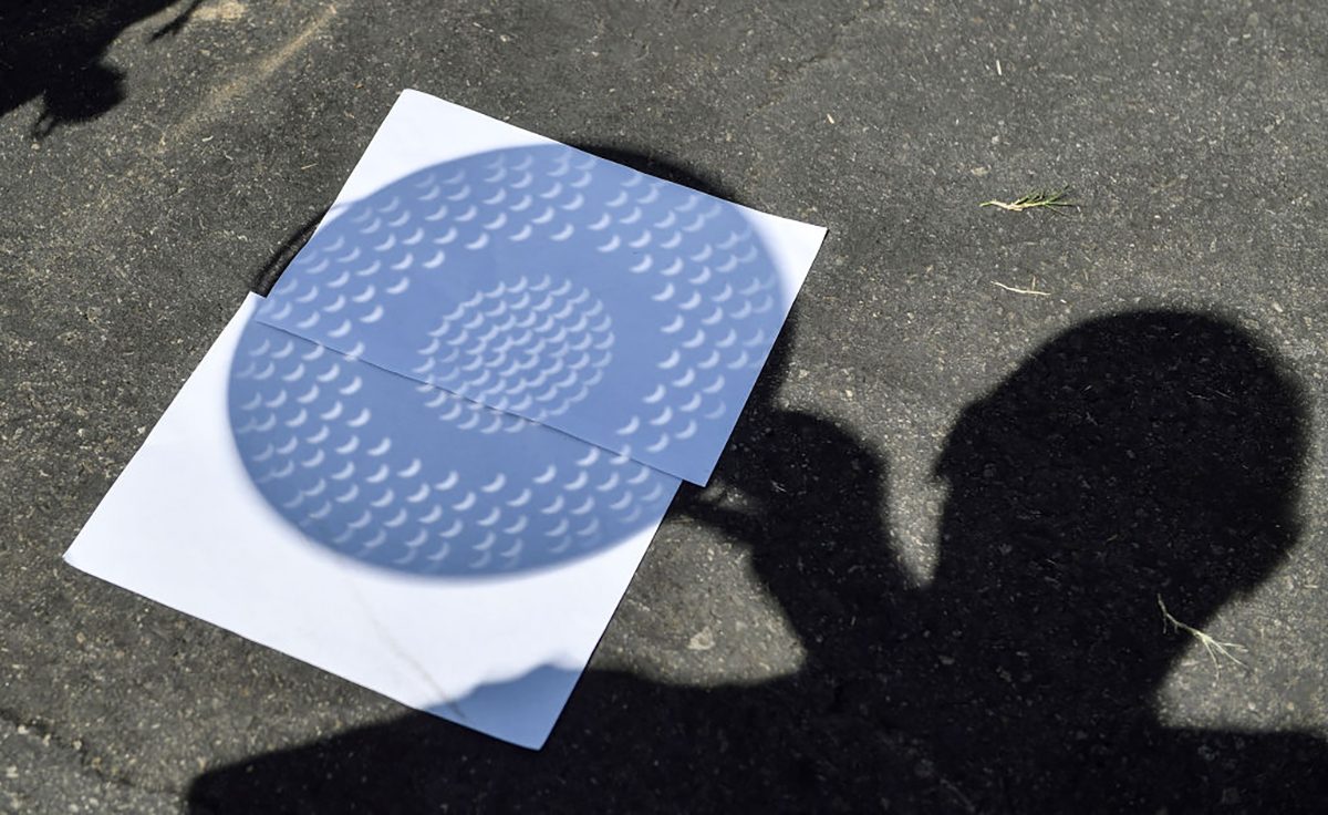 You can project the shadow of a solar eclipse by using a colander or tea strainer. This is a safe, indirect way of observing a solar eclipse without eclipse glasses and is a good option for young children. Photo by Jeff Gritchen/Orange County Register via Getty Images