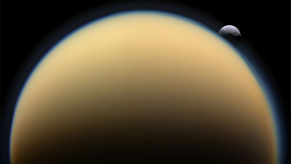 Like Earth, Titan has an atmosphere, seen here as a hazy blue outline around the moon’s limb. But Cassini scientists have discovered another similarity between our planet and Saturn’s largest moon.To the upper left of Titan in this image taken by the Cassini spacecraft is Tethys, another of Saturn’s satellites.Credit: Cassini Imaging Team, ISS, JPL, ESA, NASA