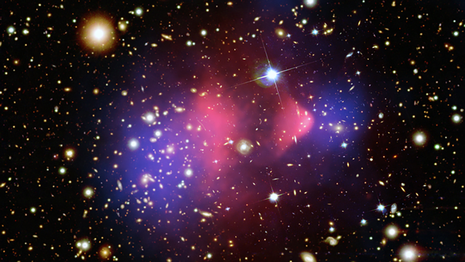 Galaxy cluster 1E 0657-56, known as the Bullet Cluster. Red represents the total visible mass and the blue hues show the distribution of dark matter in the cluster. Credit: NASA/CXC/CfA/M.Markevitch et al