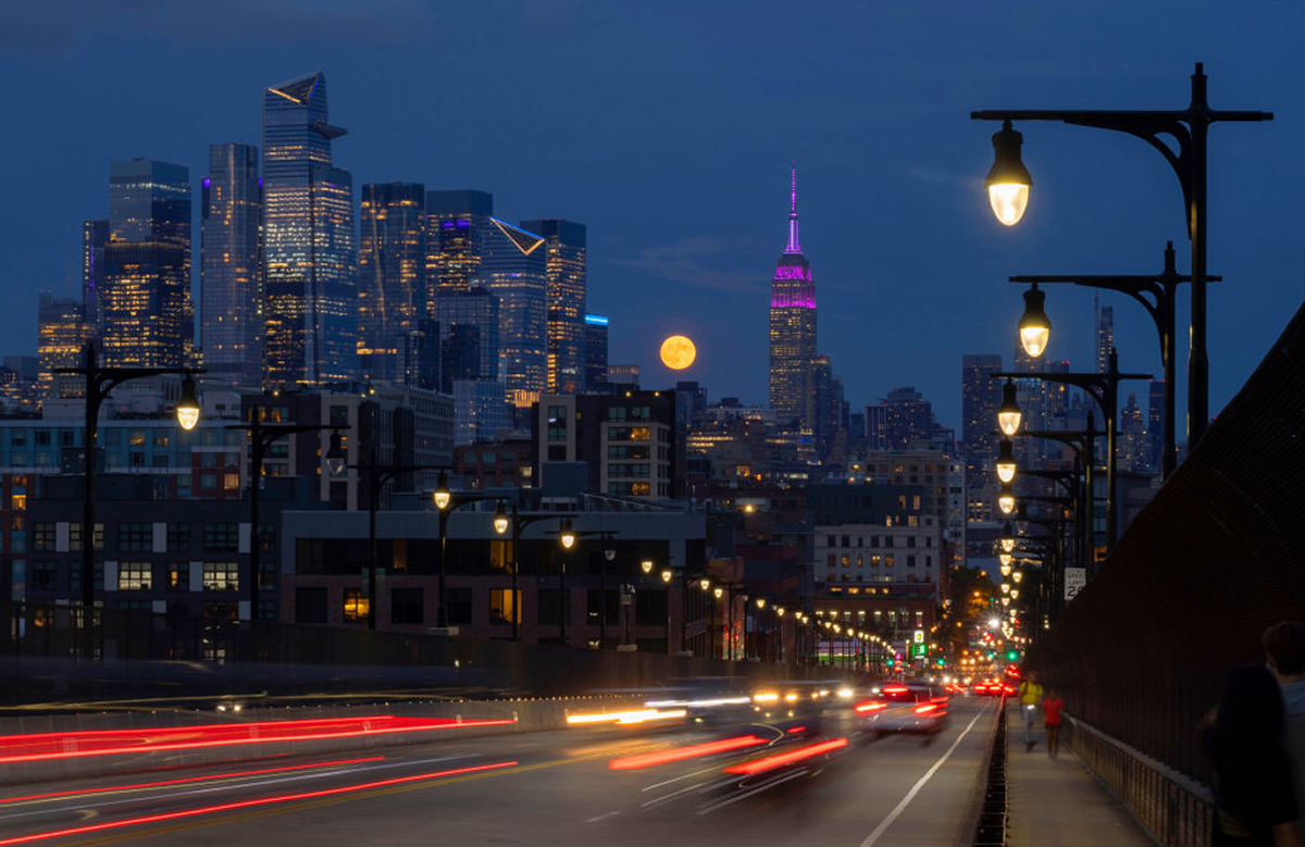 Super Harvest Moon over midtown Manhattan and the Empire State Building, New York City, USA. Foreground shows traffic along the 14th Street Viaduct, 17 September 2024. Photo by Gary Hershorn/Getty Images