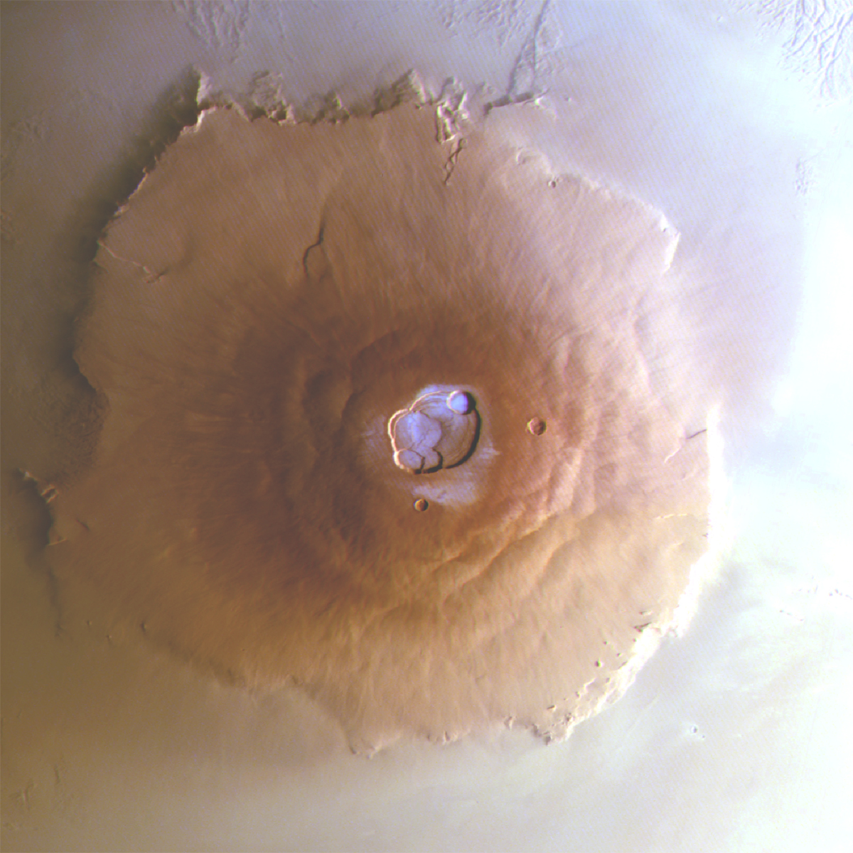 Image of Mars volcano Olympus Mons, showing frost in white-blue on top. Captured by the Mars Express orbiter. Credit: ESA/DLR/FU Berlin