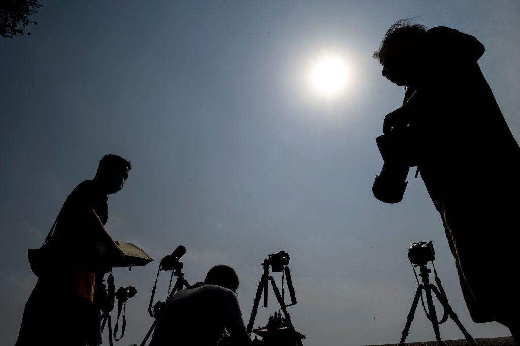 Photographers photographing the annular solar eclipse in Beijing on 21 June 2020. Photo by Noel Celis/AFP via Getty Images