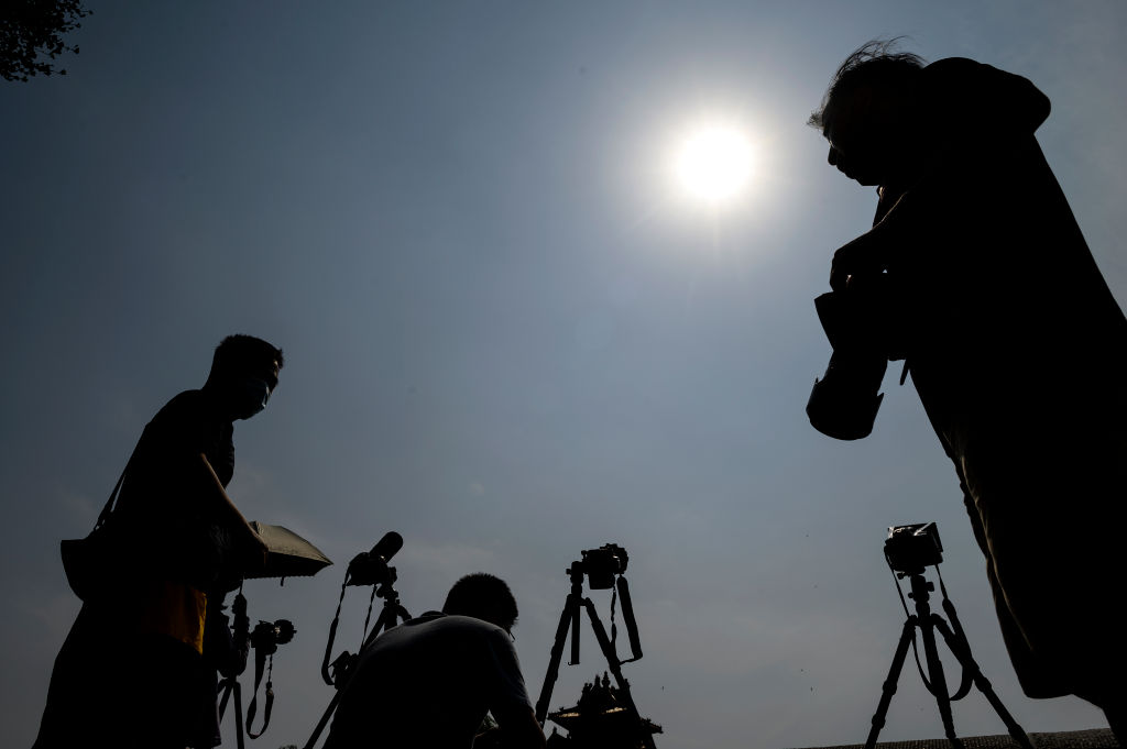 Photographers photographing the annular solar eclipse in Beijing on 21 June 2020. Photo by Noel Celis/AFP via Getty Images