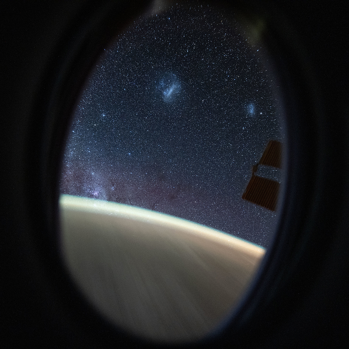 A view of the Southern Hemisphere sky, captured by Don Pettit on board the Space Station. Two fuzzy blobs at the top are the Large and Small Magellanic Clouds. The denser population of stars bottom left is the Milky Way. Credit: NASA/Don Pettit
