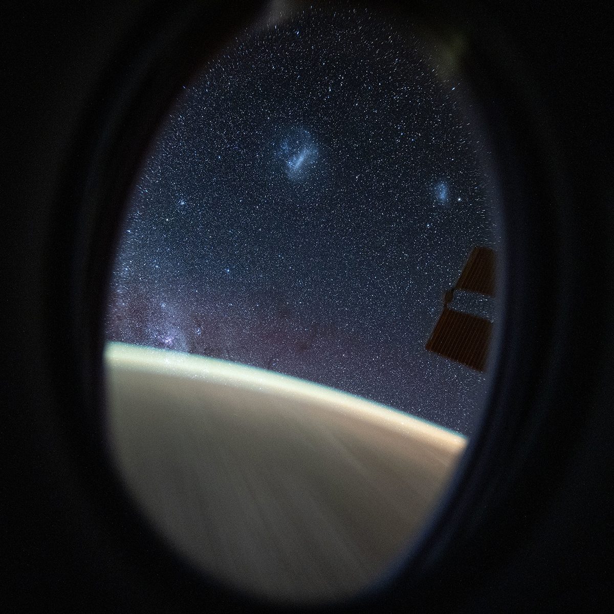 A view of the Southern Hemisphere sky, captured by Don Pettit on board the Space Station. Two fuzzy blobs at the top are the Large and Small Magellanic Clouds. The denser population of stars bottom left is the Milky Way. Credit: NASA/Don Pettit