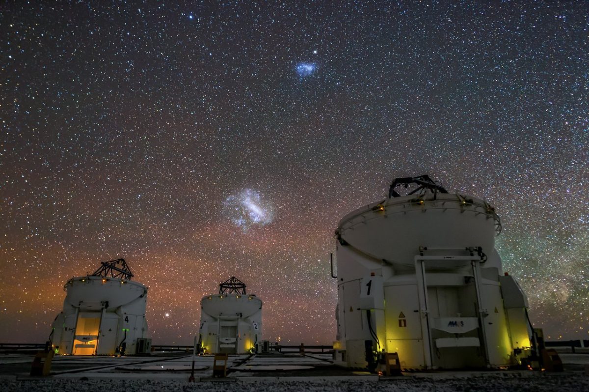 The Large and Small Magellanic Clouds appear over the Very Large Telescope in the night sky above Chile. Credit: J. C. Muñoz/ESO