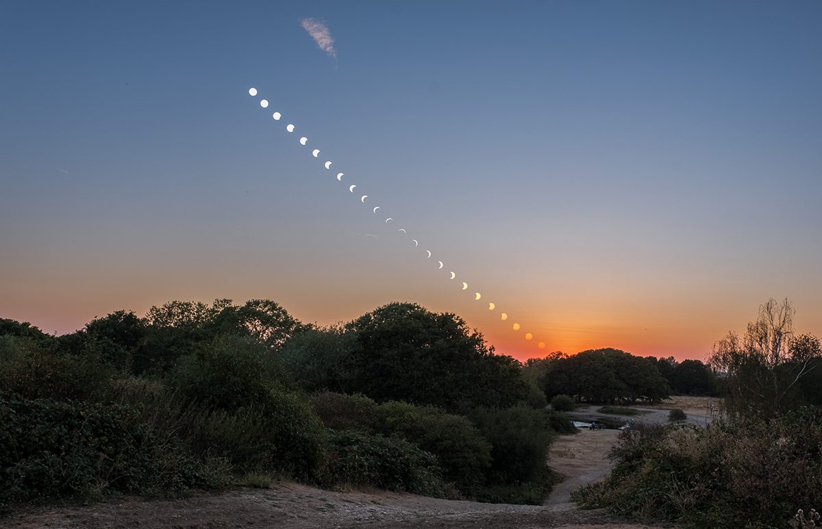 This is a composite image showing the passage of the partial solar eclipse as the Sun sets on the western horizon. It was captured by Arash Sefidgaran over Mitcham Common, London, UK on 12 August 2026. Equipment: Photo 1: Nikon Z6II camera, Sigma 150-600mm lens at 600mm, Sirui tripod, f/11, ISO 640 Photo 2: FujiFilm XH1, 23mm lens, Sirui tripod, f/13, ISO 640 Software: Lightroom, Photoshop