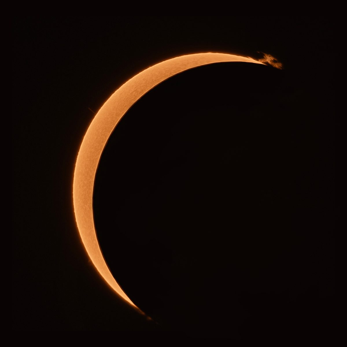 Ivana Peranic, who captured the image from the maximum point of obscurity, 12 August 2026 at 19:14 local time, from South Downs National Park, UK. Ivana says: "The lovely prominence was left on its own just as the Moon was coming up over that portion of the limb." Equipment:, ZWO 585mm camera, LUNT LS40THa/B600 h-alpha solar telescope