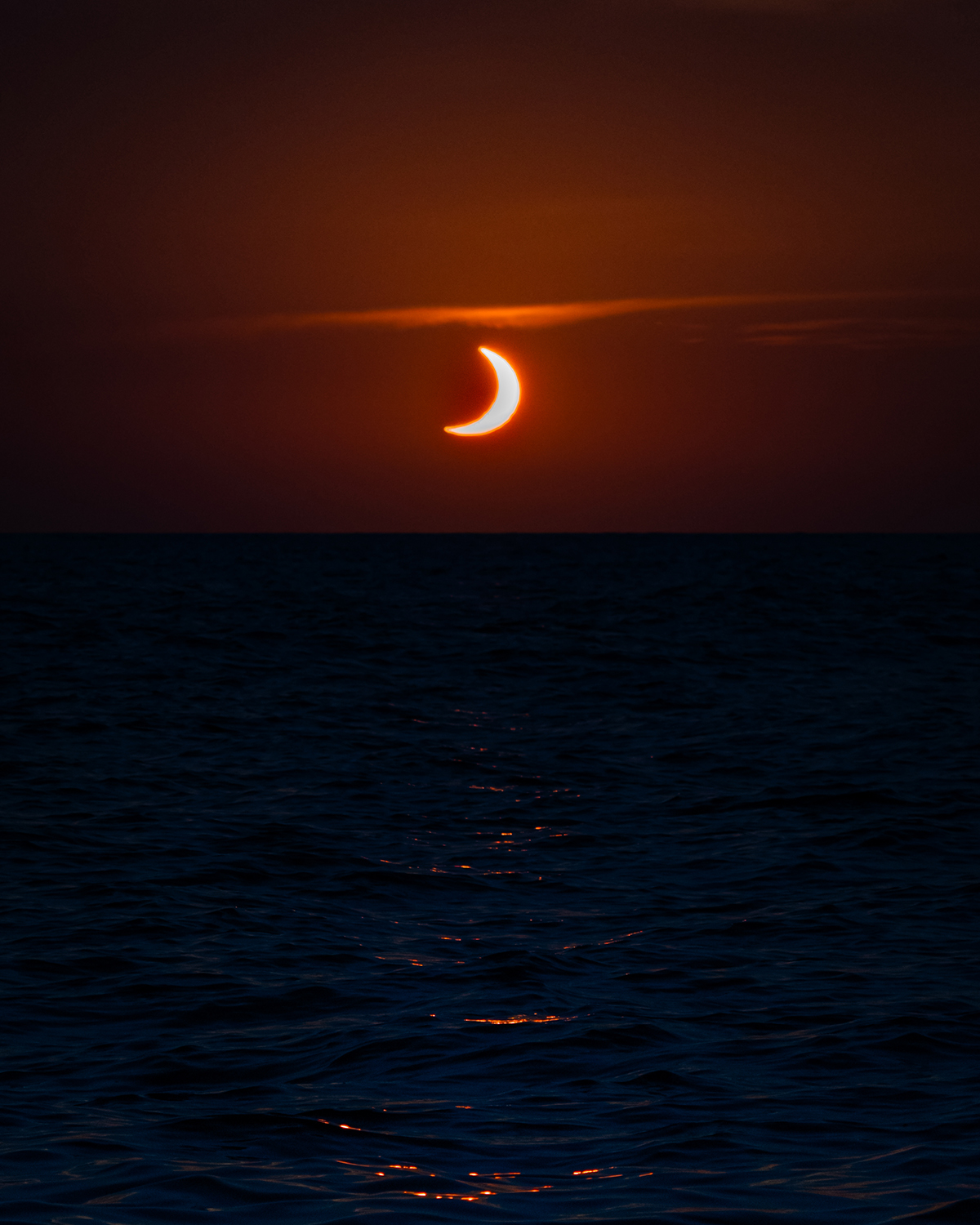 A sunset solar eclipse off the coast of Mallorca, Spain, captured by James Woods, 12 August 2026. Equipment: Sony A6600 camera, Sony 70-350mm G lens Exposure: 1/1000s, f/8, ISO 640 Software: Lightroom Mobile