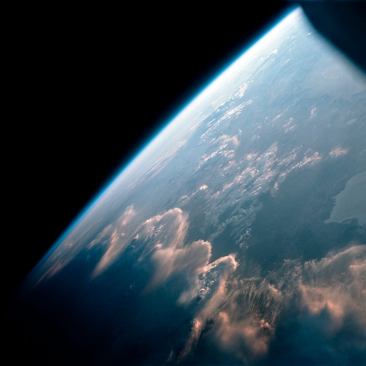 Wave clouds illuminated by the low Sun like a golden fire as Gemini 7 passes over Earth's terminator (day to night) on 12th December, 1965. Credit NASA / ASU / Andy Saunders