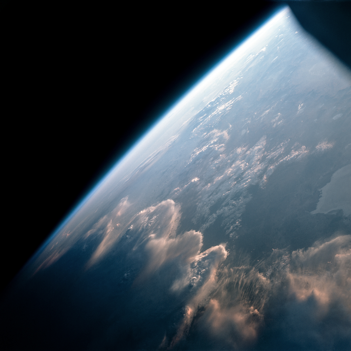 Wave clouds illuminated by the low Sun like a golden fire as Gemini 7 passes over Earth's terminator (day to night) on 12th December, 1965. Credit NASA / ASU / Andy Saunders