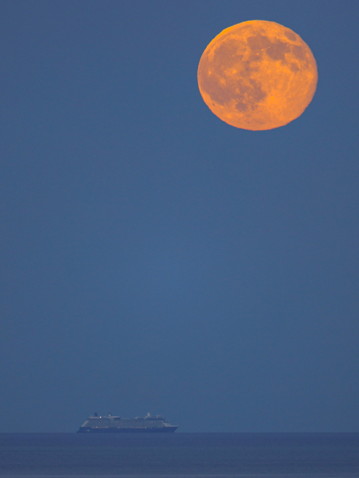 The Hunter's Moon 2026 over the sea, captured by Giovanni Passalacqua, Acireale, Sicily, Italy, 26 October 2026 at 17:15 locations time. Equipment: Canon EOS R DSLR camera, Sigma 600mm lens, Manfrotto tripod. Exposure: ISO 100, f/6.3, 1/30s Software: Photoshop
