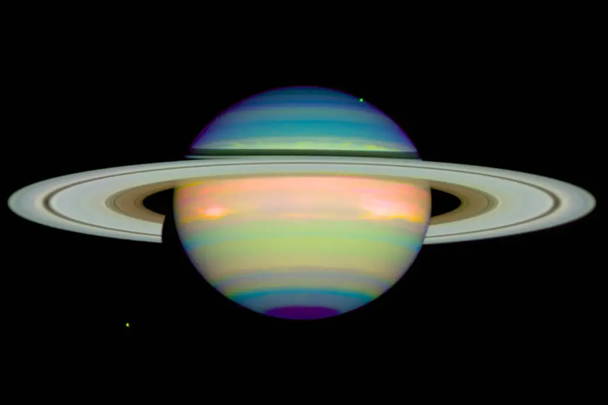 A false colour image of Saturn by the Hubble Space Telescope, showing the ringed planet in reflected infrared light. Different colours show varying heights and compositions of cloud layers thought to consist of ammonia ice crystals. Credit: NASA/E. Karkoschka (University of Arizona)