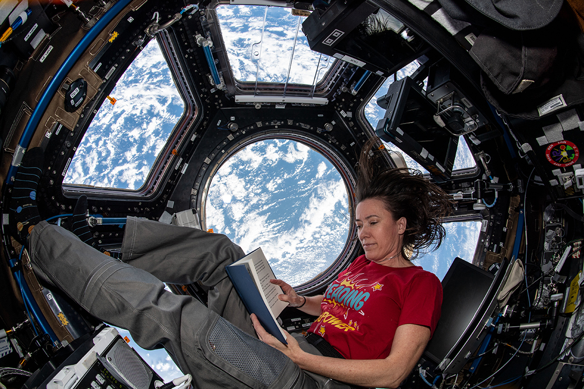 NASA astronaut Megan McArthur settles down for some light reading… or in this case, weightless reading. Credit: NASA