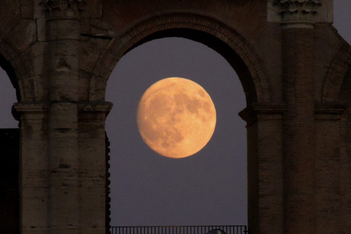 Nearly-full Sturgeon Moon captured through the arches of the Colosseum in Rome, Italy, by Paolo Palma, 7 August 2025. Equipment: Nikon Coolpix p510 camera, single shot