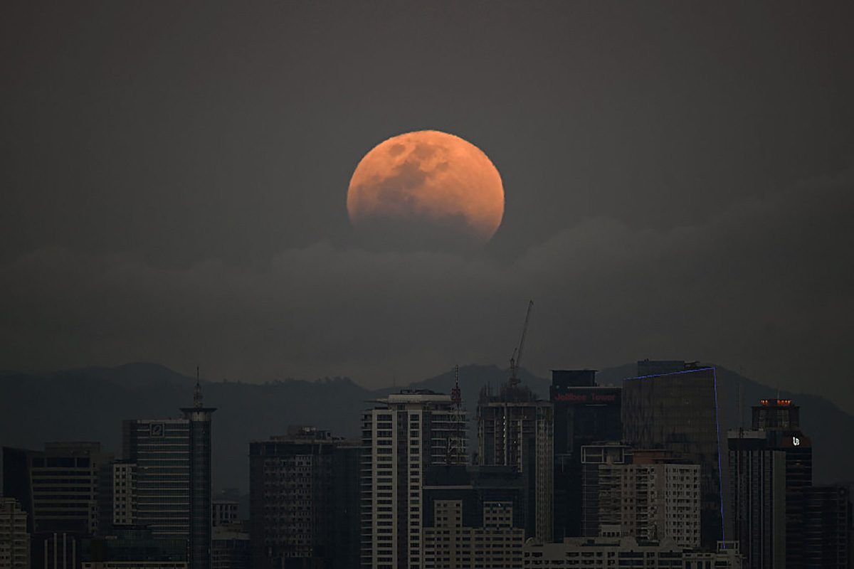 The blood Moon of March 2026 over buildings in Manila in the Philippines. Photo by Ted ALJIBE / AFP via Getty Images