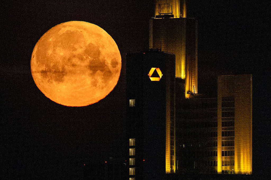 April's 'Pink Moon' seen behind the headquarters of Commerzbank bank in the banking district of Frankfurt am Main, western Germany on 12 April 2025. Photo by KIRILL KUDRYAVTSEV/AFP via Getty Images