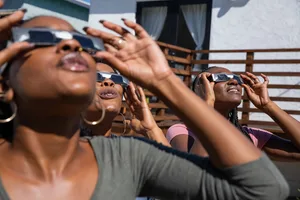 Women observing a solar eclipse safely with eclipse glasses. Credit: Leo Patrizi / Getty Women observing a solar eclipse safely with eclipse glasses. Credit: Leo Patrizi / Getty