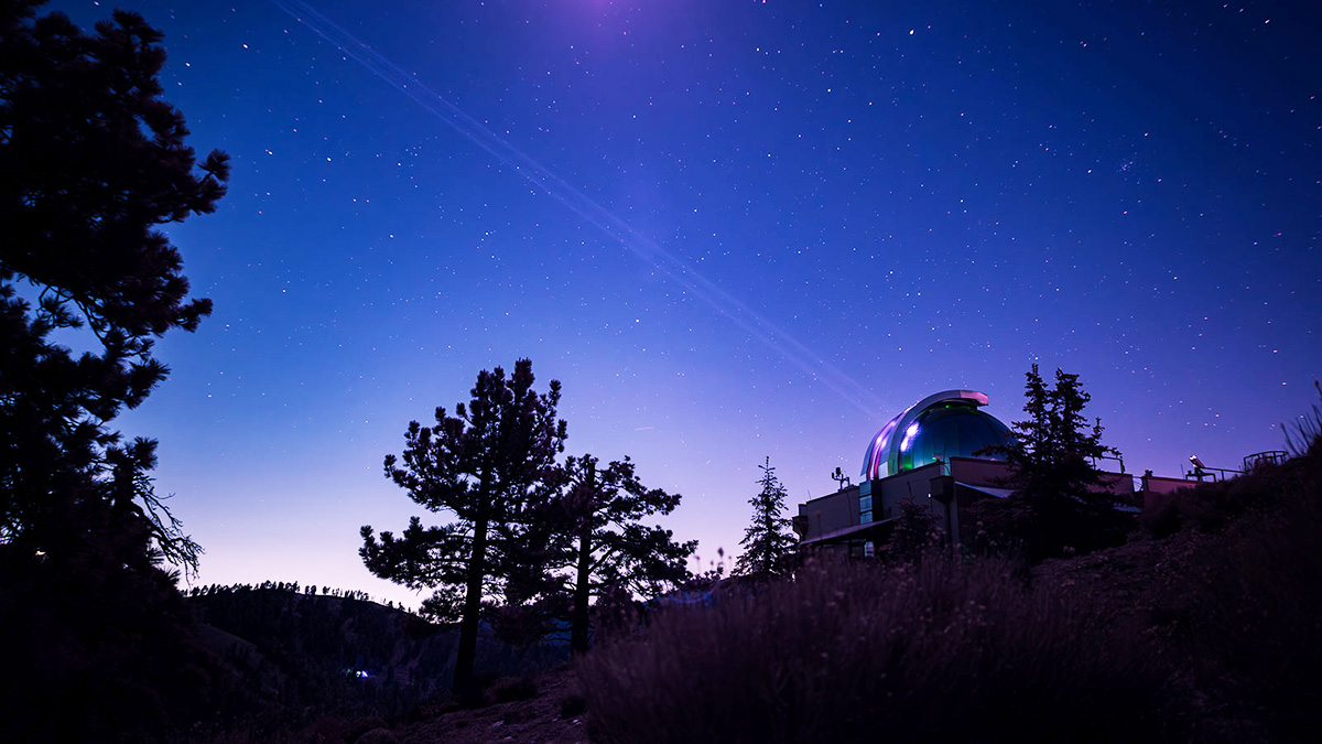 Infrared image showing the Optical Communications Telescope Laboratory at NASA JPL's Table Mountain Facility beaming a laser beacon to the DSOC flight laser transceiver aboard NASA's Psyche spacecraft. Credit: NASA/JPL-Caltech