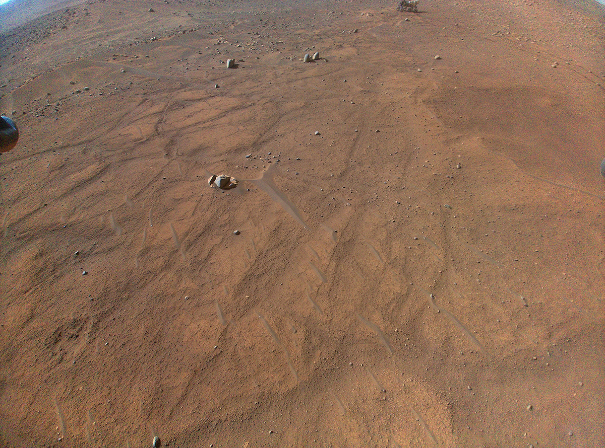 View of NASA's Perseverance rover (very top of the image, right of centre), as seen by the Ingenuity helicopter. Credit: NASA/JPL-Caltech