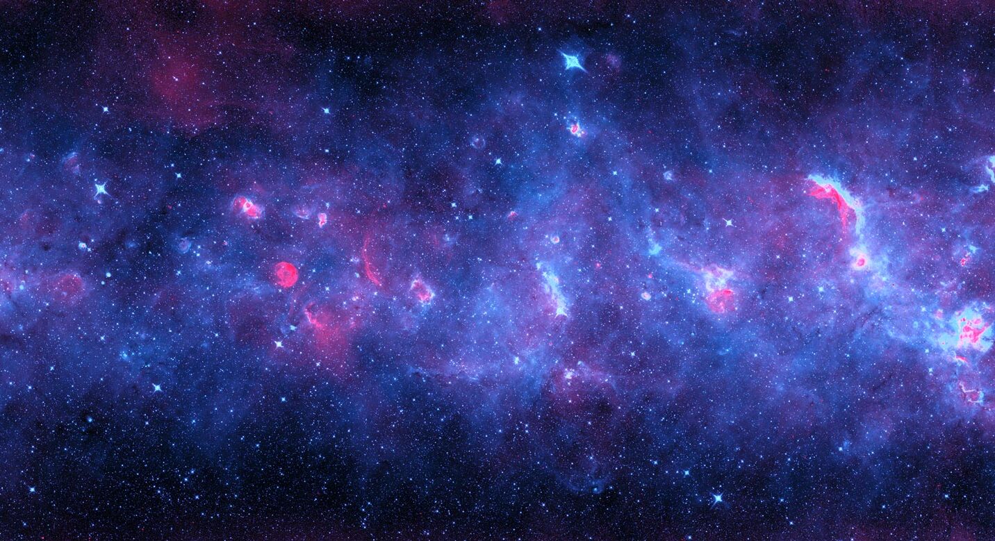 A radio and infrared image of a section of our Milky Way galaxy. Radiation from newborn stars heats cosmic dust that glows in infrared (in violet), while ultraviolet light from these stars gives off radio waves in red. Credit: NRAO/AUI/NSF
