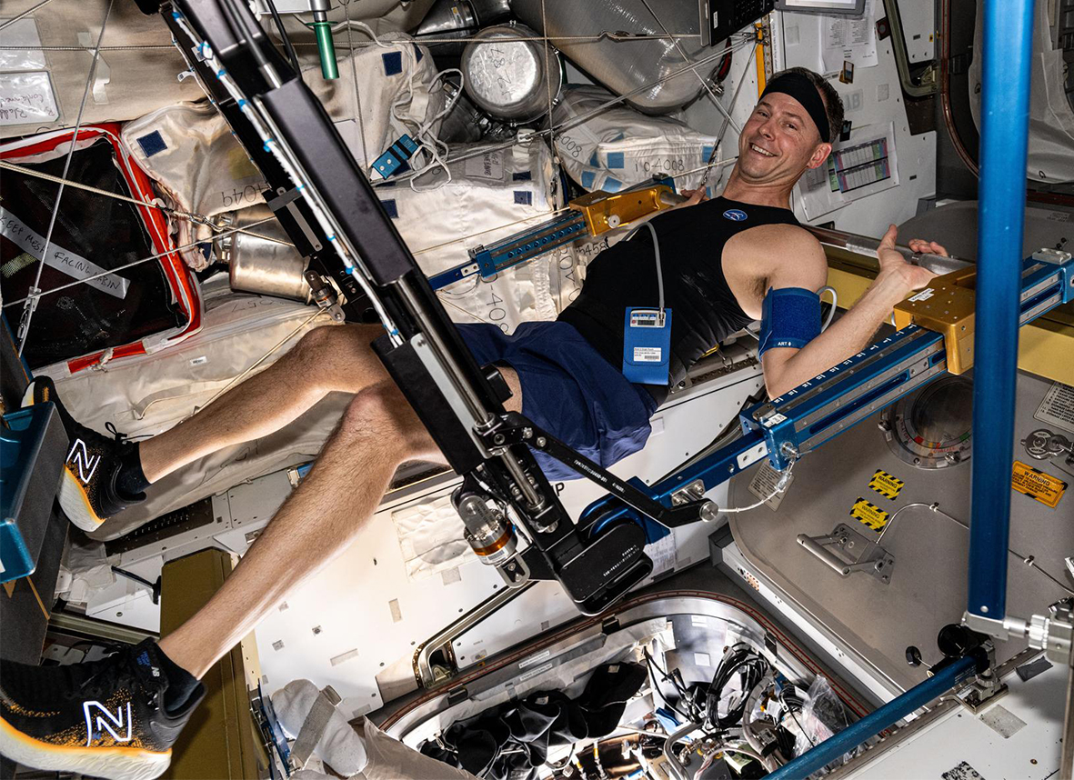 Astronaut Nick Hague exercises on the advanced resistive exercise device that mimics the inertial forces of lifting free weights on Earth