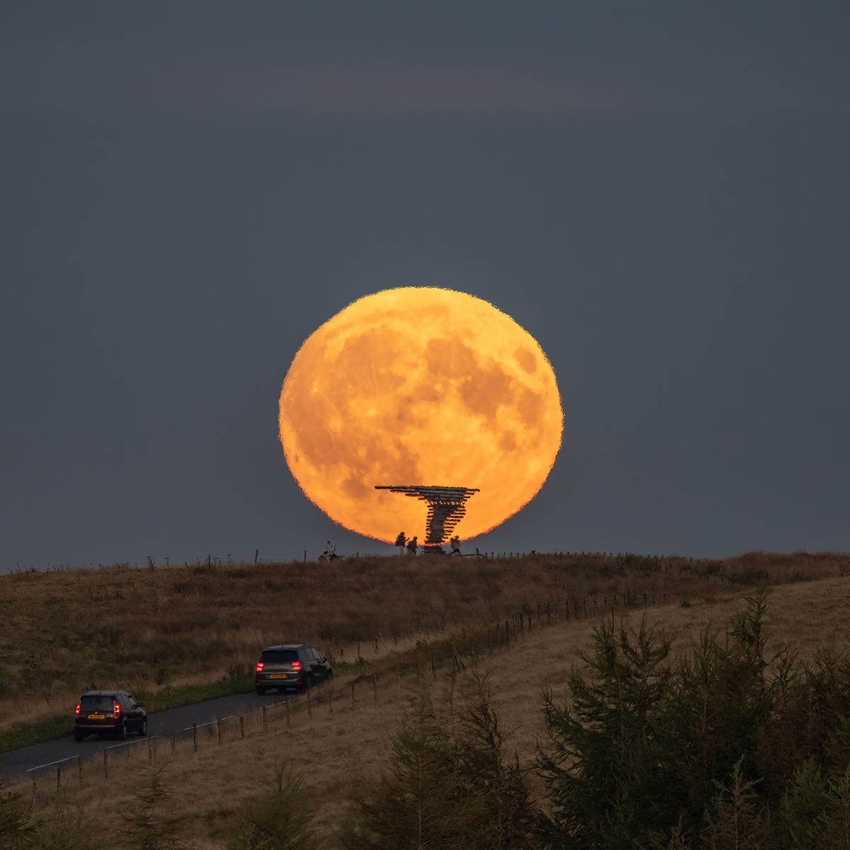 The 18 September 2024 Harvest Moon captured by Lee Mansfield over the Singing Ringing Tree sculpture, Burnley, Lancashire, UK. The Singing Ringing Tree is a wind powered sound sculpture resembling a tree set in the landscape of the Pennine hill range overlooking Burnley, in Lancashire