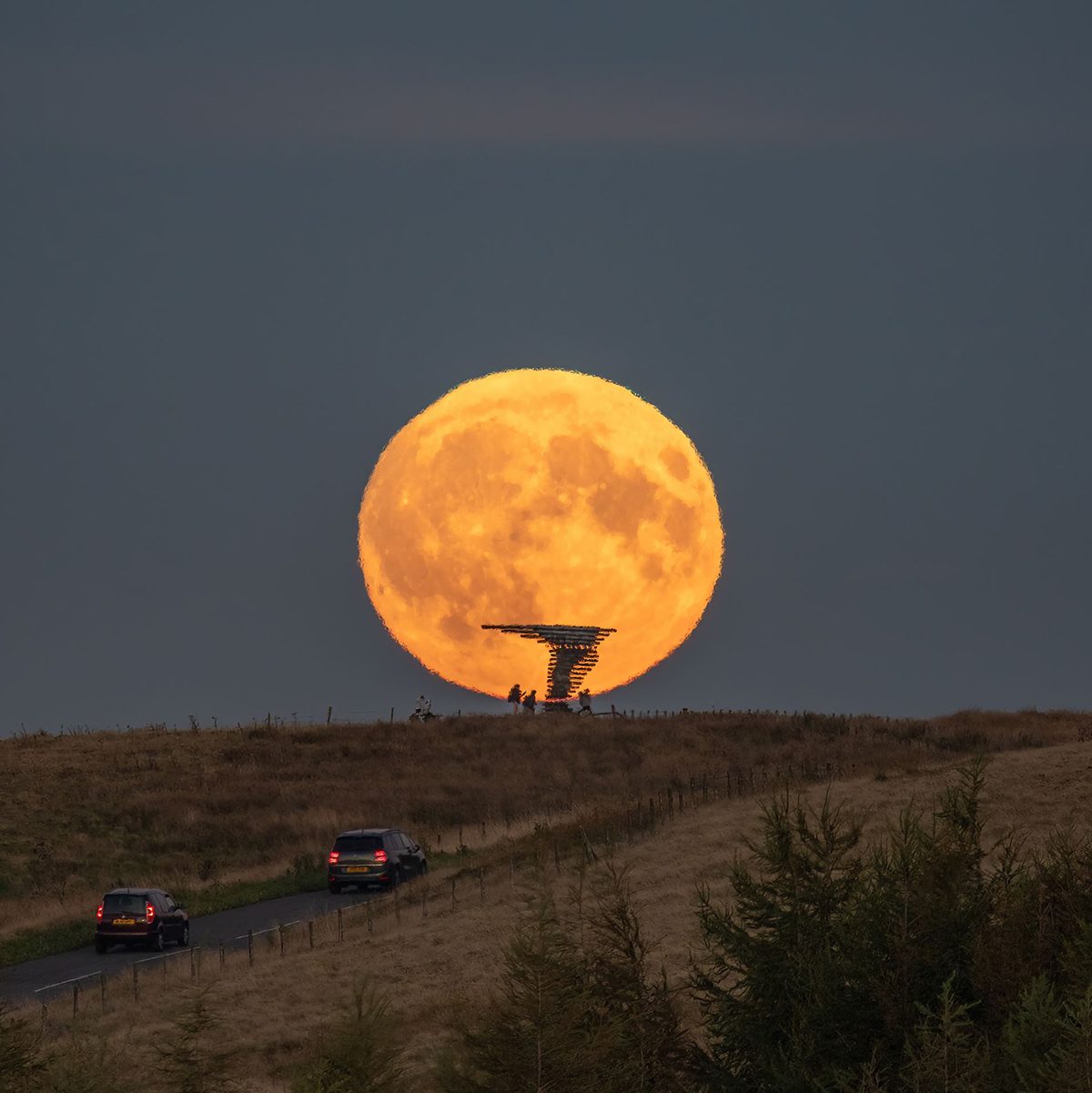 The 18 September 2024 Harvest Moon captured by Lee Mansfield over the Singing Ringing Tree sculpture, Burnley, Lancashire, UK. The Singing Ringing Tree is a wind powered sound sculpture resembling a tree set in the landscape of the Pennine hill range overlooking Burnley, in Lancashire