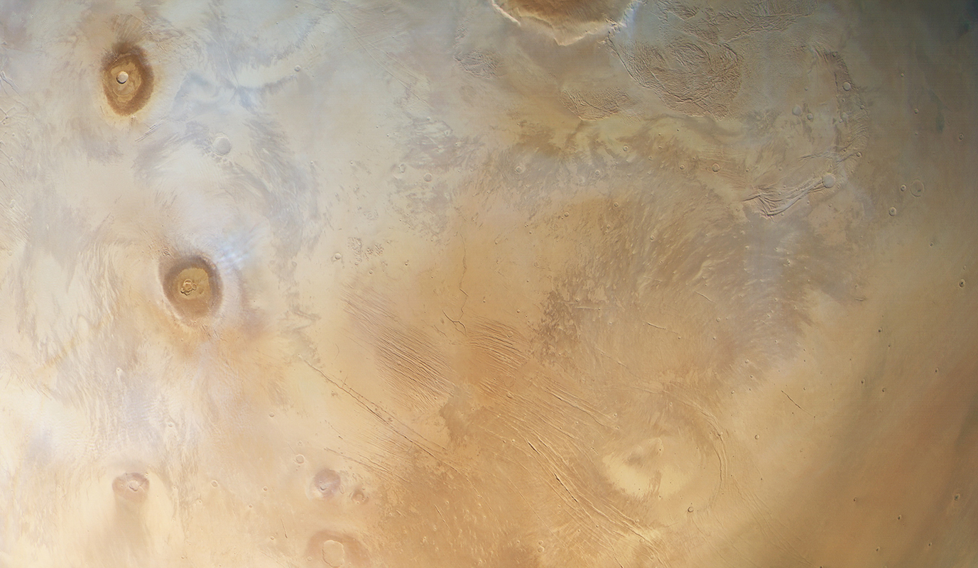 The region of Tharsis on Mars, as seen by Mars Express. The two distinct blobs are volcanoes. Credit: ESA/DLR/FU Berlin