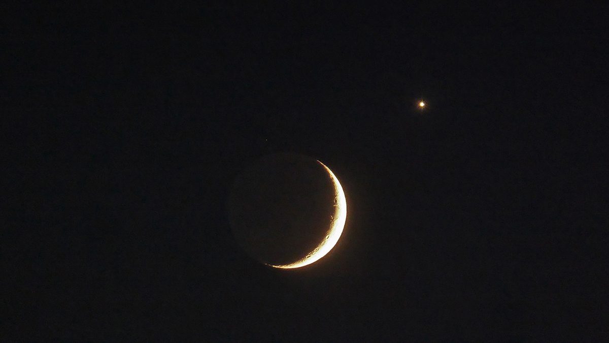A close-up shot of Venus and the crescent Moon captured by James M from Ryetop Playing Fields, Rainham, Kent, UK, 17 June 2026, 22:50 local time. Jame says: "The tiny white dot above the Moon is the magnitude +5.3 star Eta Cancri." Equipment: Panasonic DMC-TZ60 camera Exposure: ISO 1600, f/6.4, 1/6s, Software: Photoshop