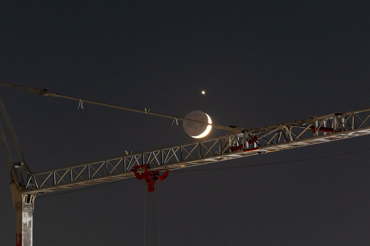 Paolo Barrella sent us this image of Venus and the crescent Moon captured from Scandicci, Florence, Italy, 17 June 2026. 23:02 local time. Paolo says: "This image shows a beautiful crescent Moon — with Earthshine clearly visible on its dark limb — in close conjunction with the bright planet Venus, framed by the lattice structure of a construction crane. "The juxtaposition of the industrial foreground and the delicate lunar crescent creates, I feel, a rather striking contrast." © Paolo Barrella. Equipment: Canon EOS 1300D DSLR camera, Canon EF-S 55–250mm lens, f/4–5.6 IS STM @ 135 mm Exposure: ISO 800, f/5.0, 3.2 s