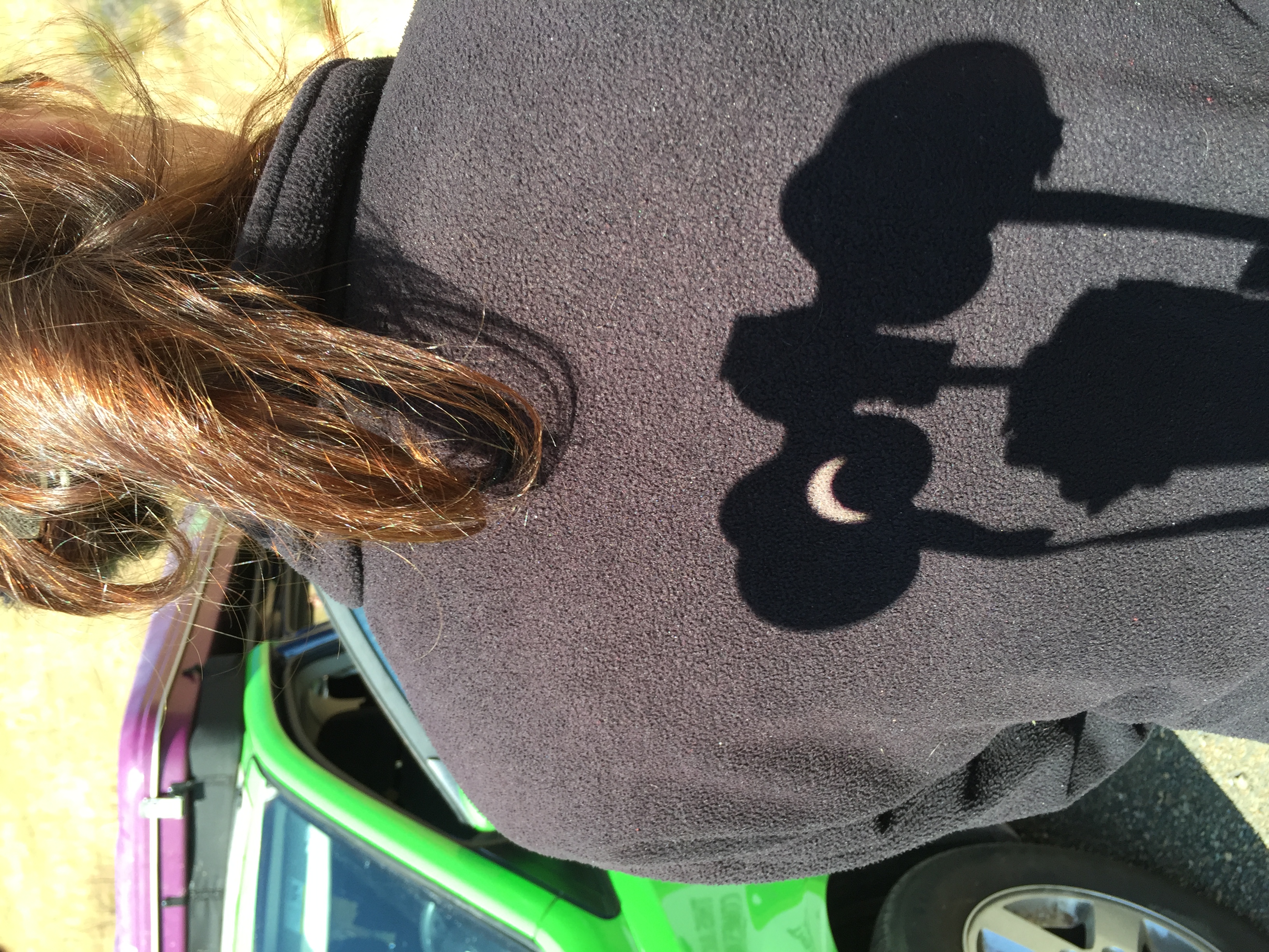 Talk about solar projection! A view of a solar eclipse projected through binoculars and onto a fellow eclipse chaser's back. Credit: Nick Spall.