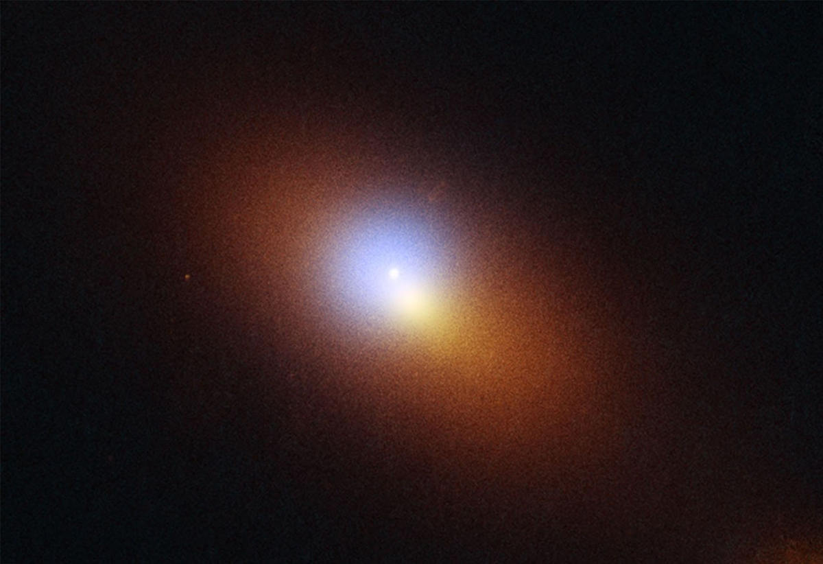 A Hubble Space Telescope and Chandra X-ray Observatory image of a galaxy 600 million lightyears away that's host to the signature of a roaming supermassive black hole. The bright dot is tidal disruption event AT2024tvd, which is a flash of radiation caused by the supermassive black hole eating a star. Credit: NASA, ESA, STScI, Yuhan Yao (UC Berkeley); Image Processing: Joseph DePasquale (STScI)